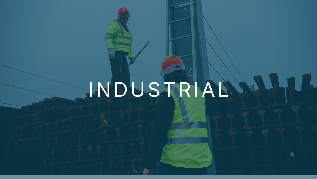Two workers in hi-vis and hard hats working at height