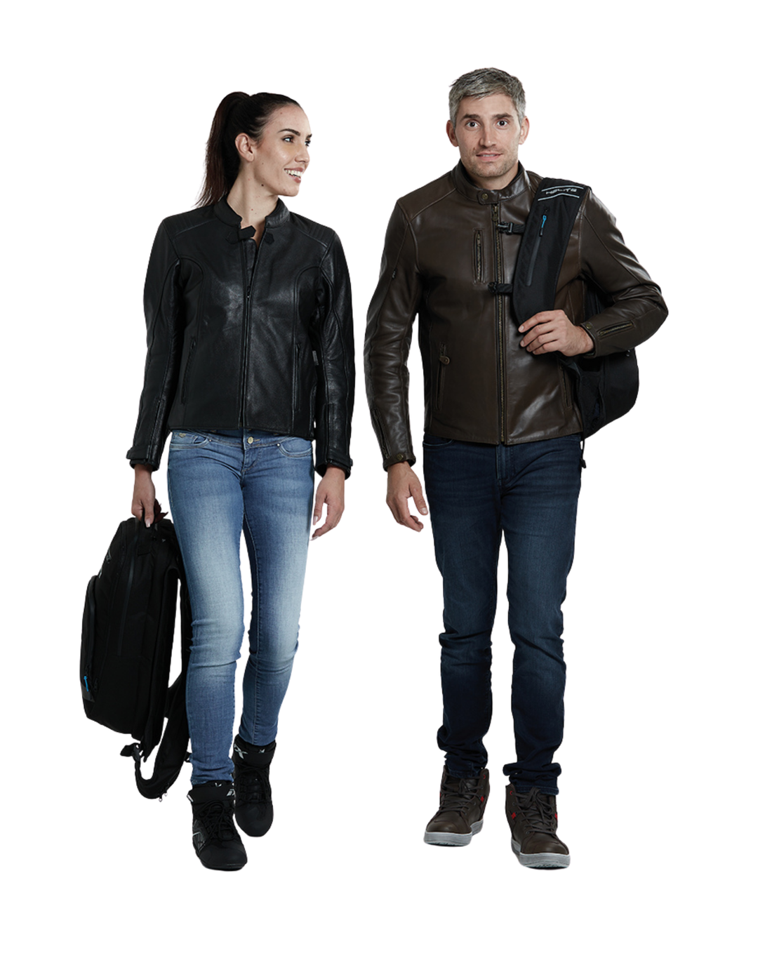 Two riders walking, one carrying the Helite H-Moov airbag backpack by the handle