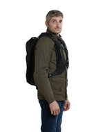 Man wearing the Helite H-Moov airbag backpack over a jacket, three-quarter view