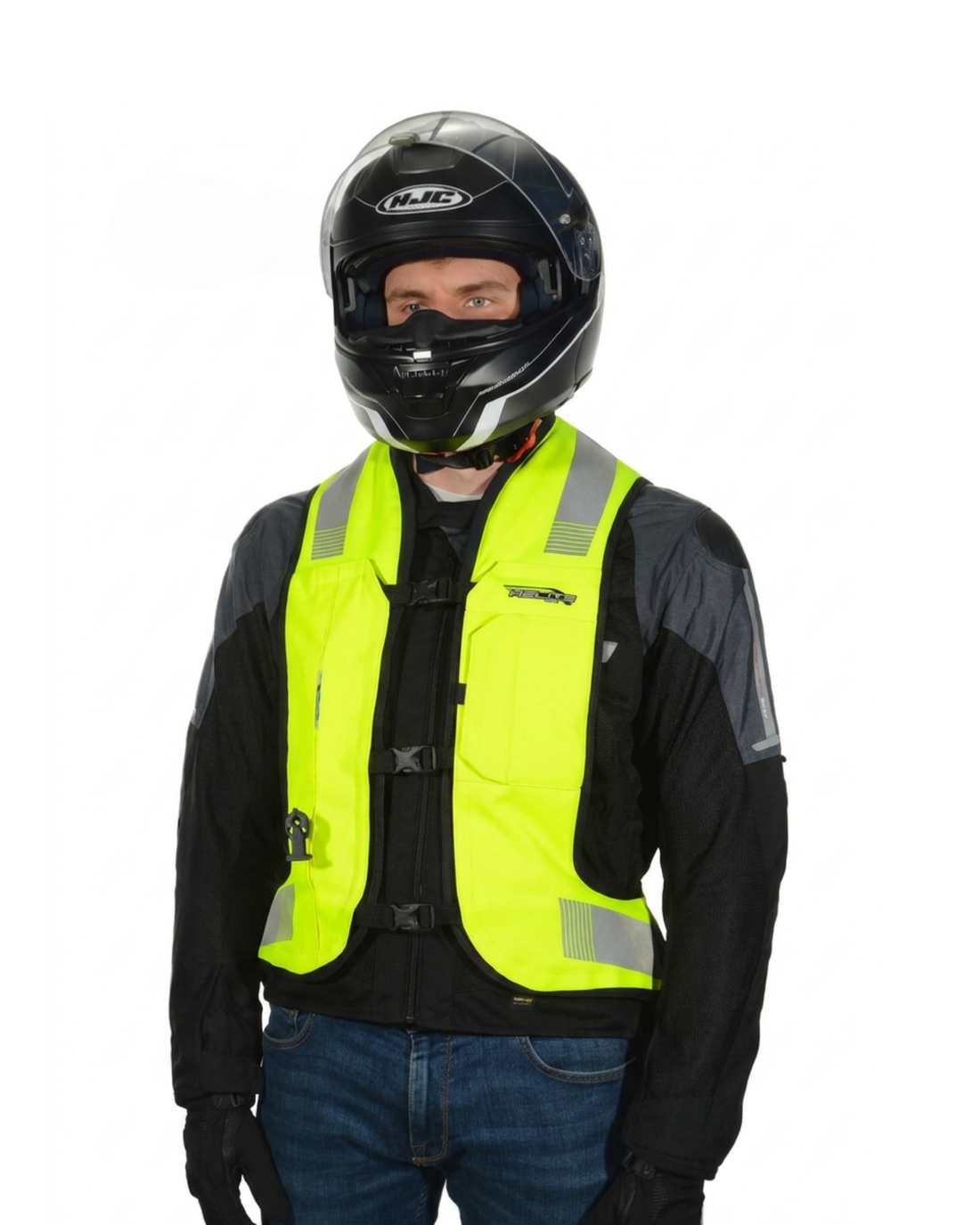 Rider in a full-face helmet wearing the high-vis Turtle 2 airbag vest over a motorcycle jacket