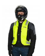 Rider in a full-face helmet wearing the high-vis Turtle 2 airbag vest over a motorcycle jacket