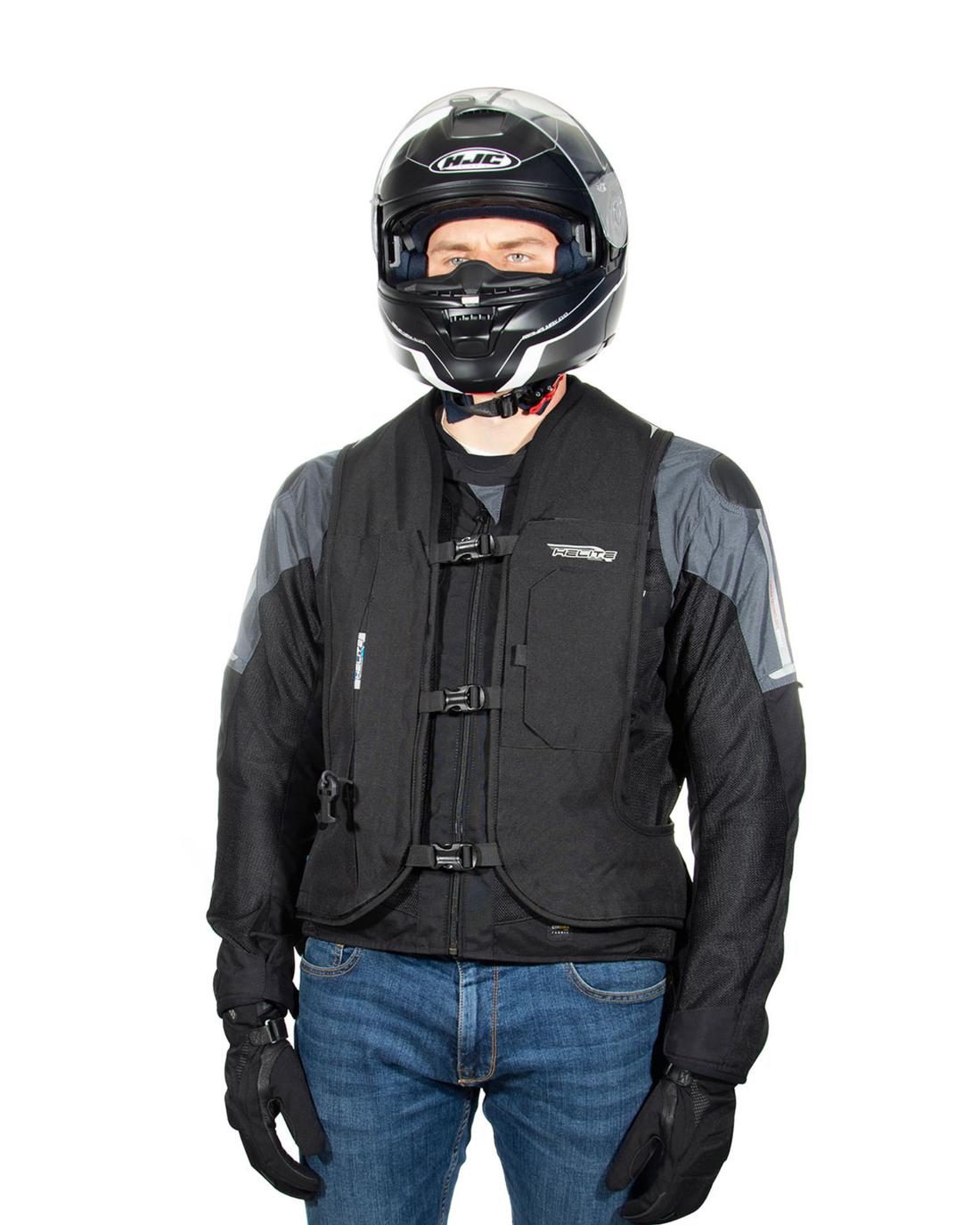Rider in a full-face helmet wearing the black Turtle 2 airbag vest over a motorcycle jacket