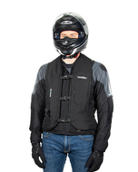 Rider in a full-face helmet wearing the black Turtle 2 airbag vest over a motorcycle jacket