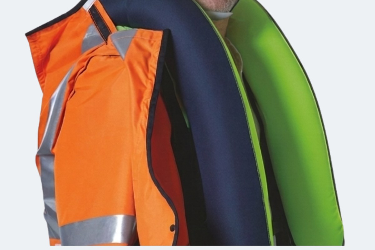 Close-up of both Air'Fall airbags inflated around the neck and upper body, worn under an orange hi-vis jacket