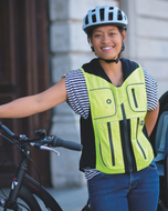 Cyclist with her bike wearing the high-vis Helite B'Safe airbag vest