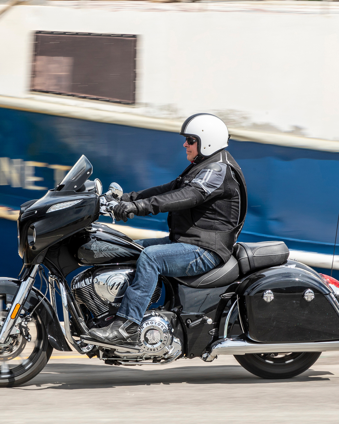 Motorcyclist riding a cruiser while wearing the black e-Turtle electronic airbag vest