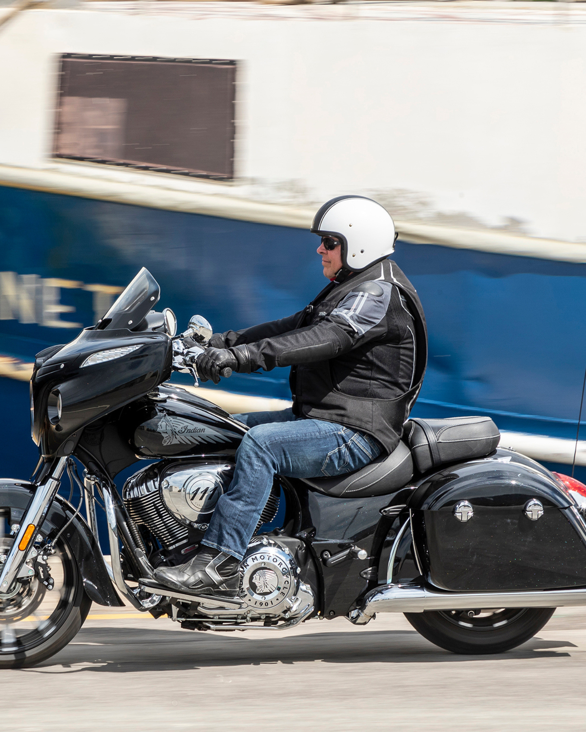 Motorcyclist riding a cruiser while wearing the black e-Turtle electronic airbag vest