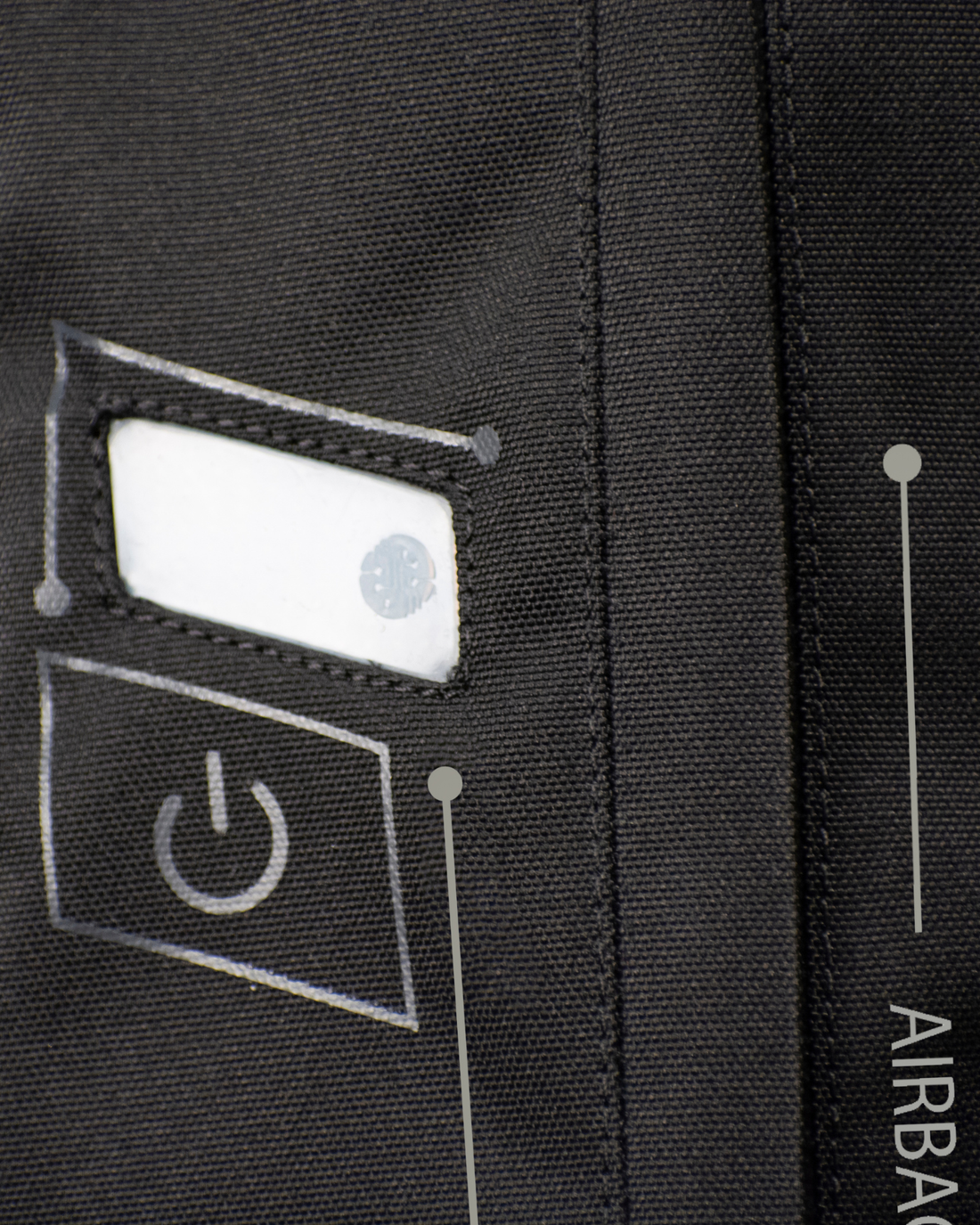 Close-up of the power button and status light on the black e-Turtle airbag vest