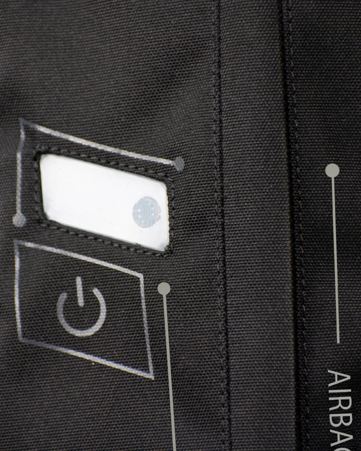 Close-up of the power button and status light on the black e-Turtle airbag vest