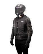 Rider in a leather jacket wearing the black e-Turtle electronic airbag vest