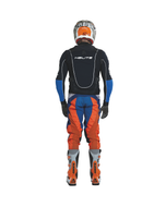 Motocross rider in a helmet seen from behind wearing the Helite Off Road airbag vest